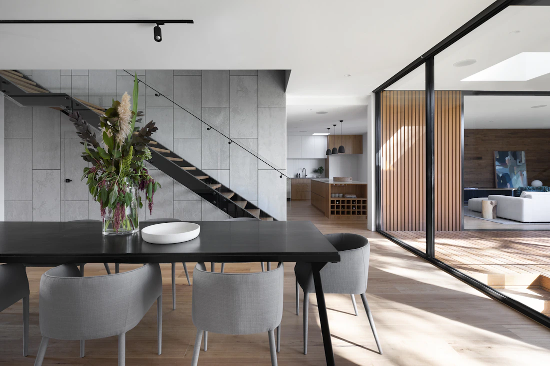 Modern staircase beside a dining area